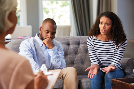 Young couple in crisis trying solve problem during counselling
